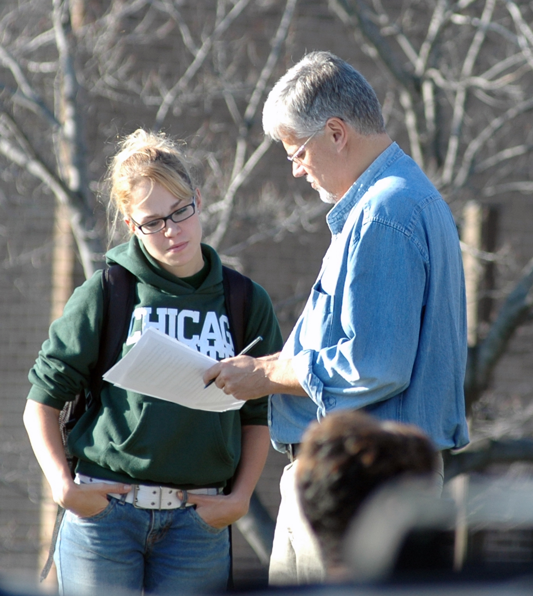 Chicago State instructor working with a student in the quad