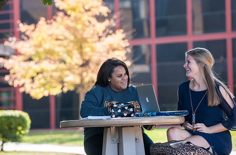 CU Chicago Campus - Students interacting at a table outside